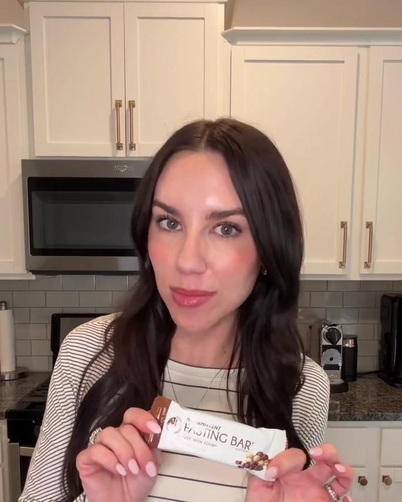 Jennifer Mazonas in her kitchen holding a wrapped Prolon Fasting Bar